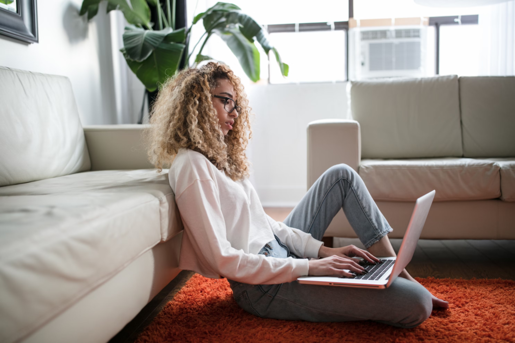 A Girl Sitting on the floor using her laptop